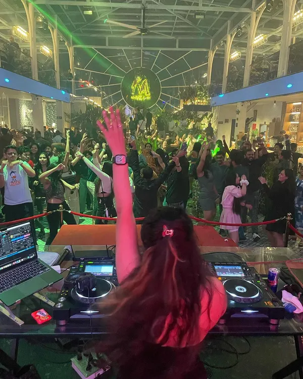 This is my view from the decks, connecting with a packed house. I live for these moments, feeling the energy of the crowd and guiding the night with a mix of high-energy Bollywood and Punjabi tracks.