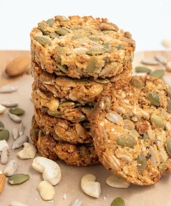 A stack of our healthy and wholesome multi-seed cookies. They are packed with nutritious ingredients like pumpkin seeds, sunflower seeds, almonds, and cashews.
