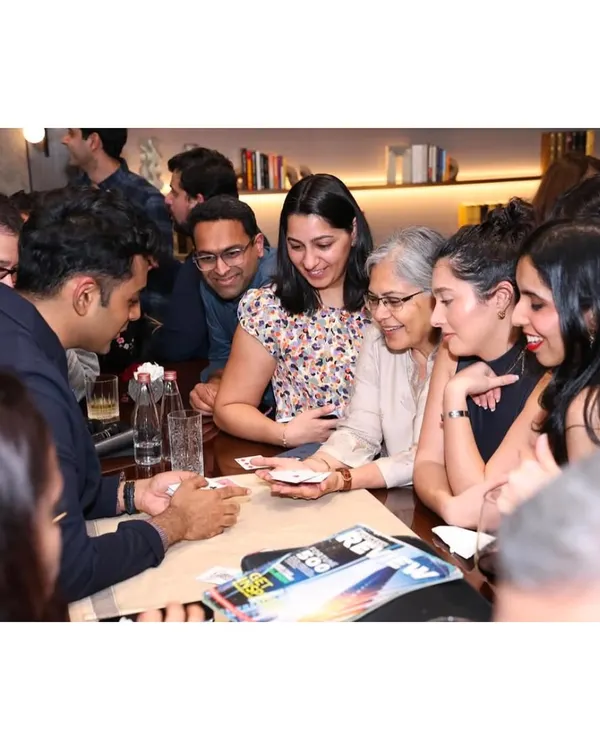A perfect example of close-up magic. A group of guests huddle around a table, watching intently as the cards come to life in my hands.