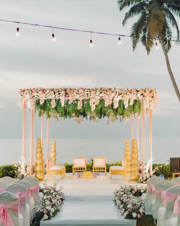 A dream destination wedding mandap in Goa. This setup by the sea, with its lush floral canopy and elegant seating, created an unforgettable backdrop for the vows.