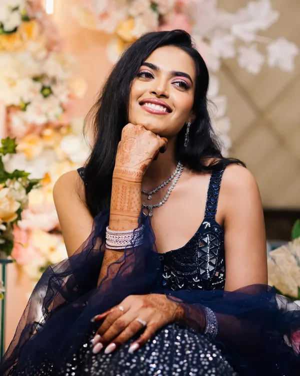A beautiful, candid portrait of the bride, her face lit up with a genuine smile. This shot captures her natural joy and radiance during the engagement festivities.