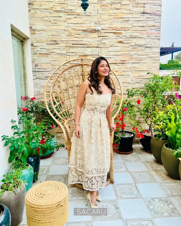 Our co-founder Pooja dressed in a custom georgette appliqué lace dress, embellished with lace flowers and crystals for a charming summer look.