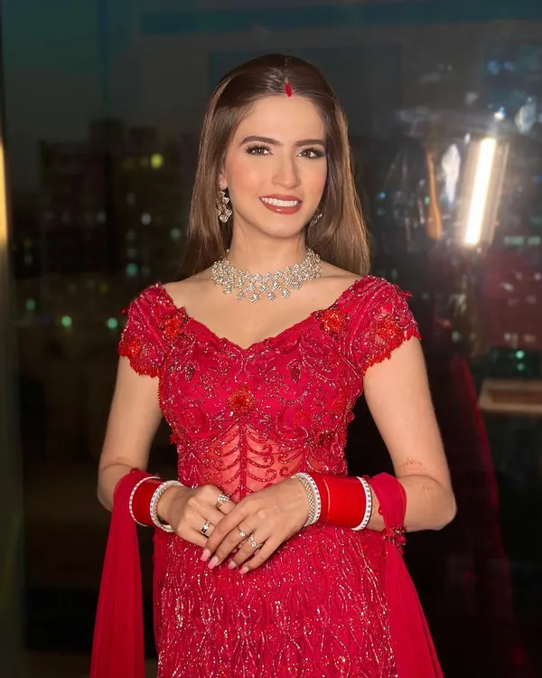 Bold, beautiful, and breathtaking in red. This new bride's reception look is a modern take on tradition, featuring a flawless base and a radiant smile.