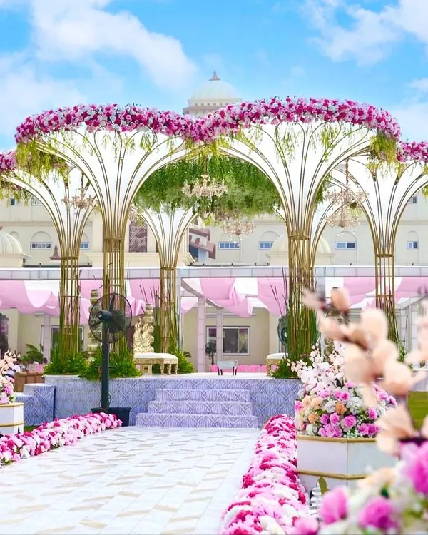 Our signature Lotus Vidhi Mandap creates a truly royal and unforgettable setting for your vows. We designed this magnificent structure to stand out against the palatial backdrop, using thousands of pink and white florals to craft an atmosphere of pure romance and grandeur.