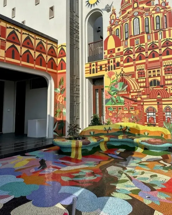 A complete view of our immersive installation in Rajkot, where a vibrant floor mosaic flows seamlessly into a sculptural bench and up a building facade. This project is a testament to our philosophy of using any surface and any material to create a magnificent experience.