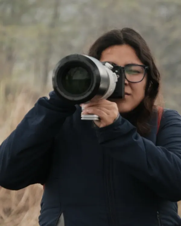 A portrait of me looking through the viewfinder of my camera, equipped with a large telephoto lens. This is my focused, in-the-zone look when I'm shooting wildlife.