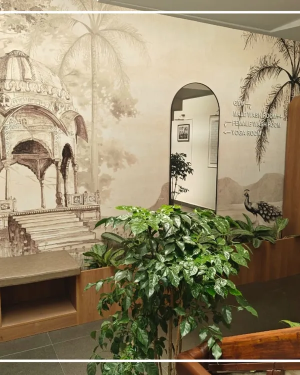 This transition space at the Bangalore Club captures my approach to adaptive reuse. The custom PVC wallpaper, featuring illustrations of historic Indian architecture and peacocks, creates a narrative wall that guides members through the health club while honoring the building's colonial roots.