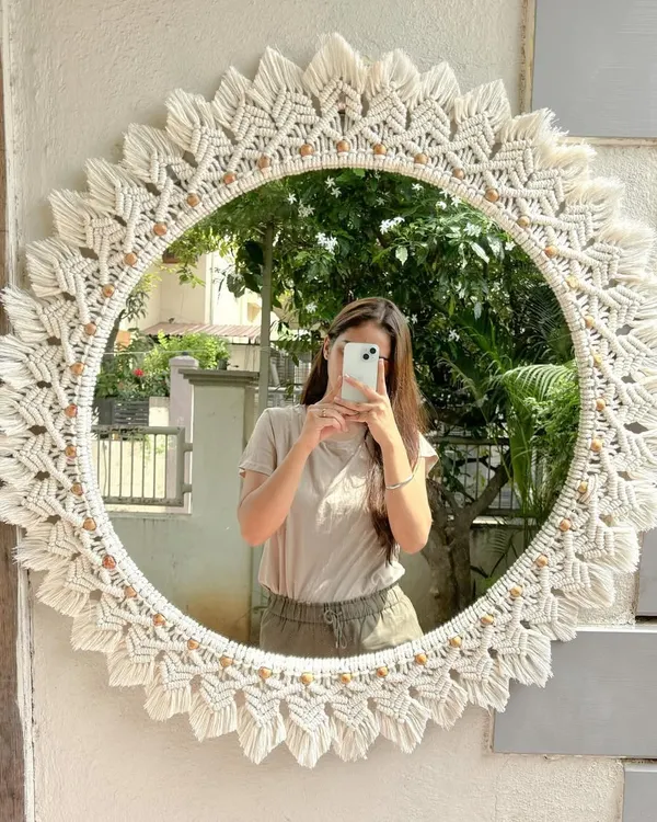 This is our largest macrame mirror to date, a 30-inch showstopper made for a client's living room. The intricate knotting and detailed leaf pattern create a stunning focal point, perfect for adding a touch of handmade elegance to any wall.