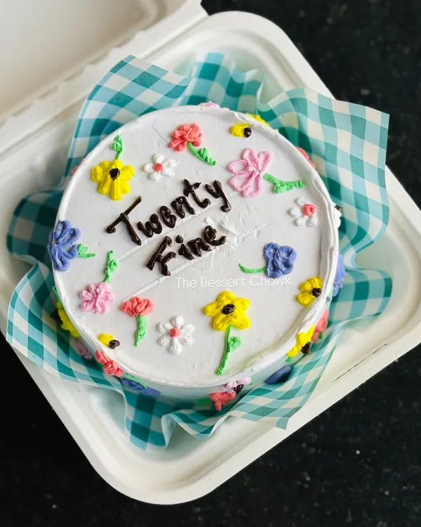 A "Twenty Fine" bento cake with cute, colourful, hand-piped flowers. These Korean-style lunchbox cakes are perfect for a trendy and personal celebration.