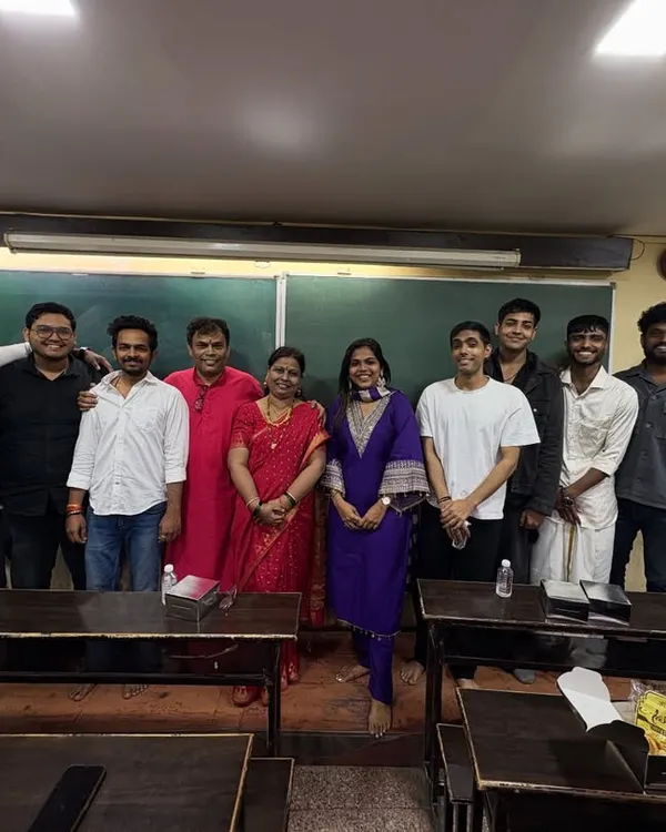 The complete team of teachers and staff posing for a group photo during the Satyanarayan Pooja.
