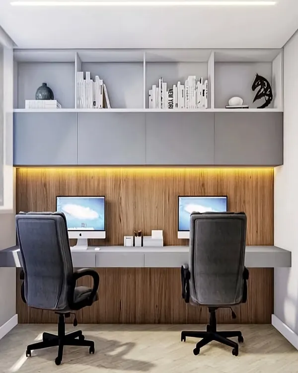 A sleek and modern study area for two. I designed this with a long floating desk, handle-less overhead cabinets, and a wood-paneled wall with warm backlighting.