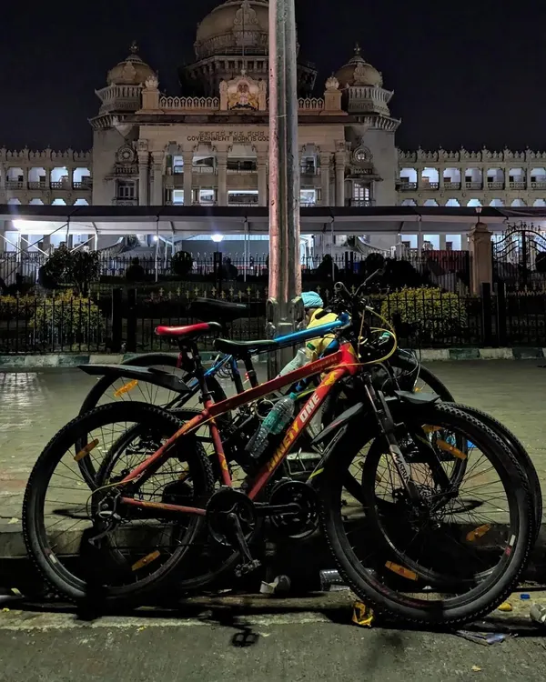 Our cycles parked in front of the magnificent Vidhana Soudha at night. Exploring Bangalore's landmarks after dark, when they are beautifully lit and free of crowds, is a core part of our rides.