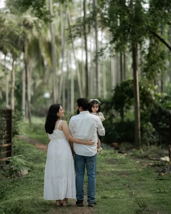 A family's journey is a story told one step at a time. This candid shot captures a family walking together through the woods, a simple moment that speaks volumes about their bond. It’s not about looking at the camera, but about being present with each other.