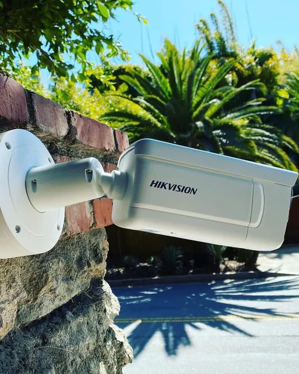 A professionally installed Hikvision bullet camera, mounted on a brick wall to secure a residential property. This type of durable, weatherproof camera is ideal for monitoring entry points and outdoor areas, providing clear footage day and night.
