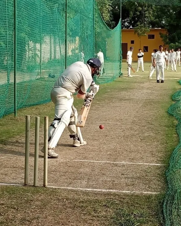 A batsman perfects his defensive stroke during a net session. Our coaches focus on mastering the fundamentals, ensuring every player has a solid and reliable technique.