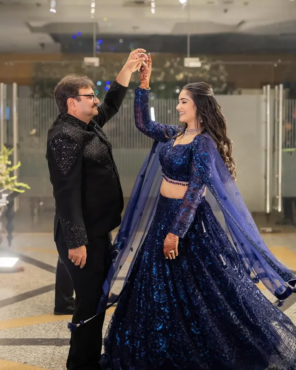 A father-daughter dance is a precious memory. My flowing, sequined blue lehenga was designed for movement, allowing me to twirl and dance comfortably all night long.