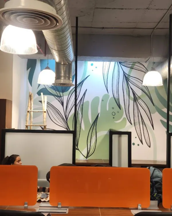 A minimalist botanical doodle art mural designed for a modern workspace. The clean lines and soothing green tones bring a sense of calm and nature into the office environment.