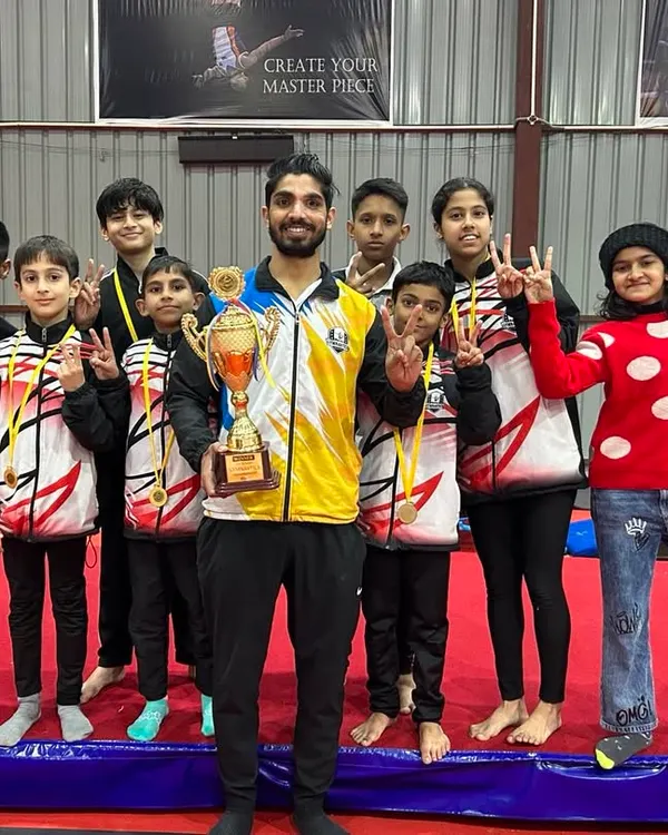 Posing with my team and our trophy after a successful competition. Seeing their proud faces is the greatest reward for a coach.