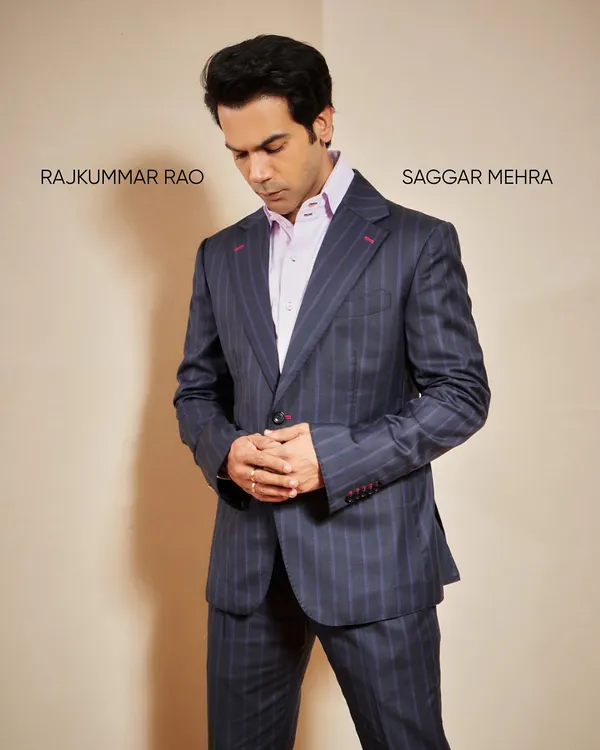 A contemplative moment with Rajkummar Rao in my tailored pinstripe suit. This angle shows the structure of the shoulders and the clean lines of the lapel, key elements of classic bespoke tailoring.