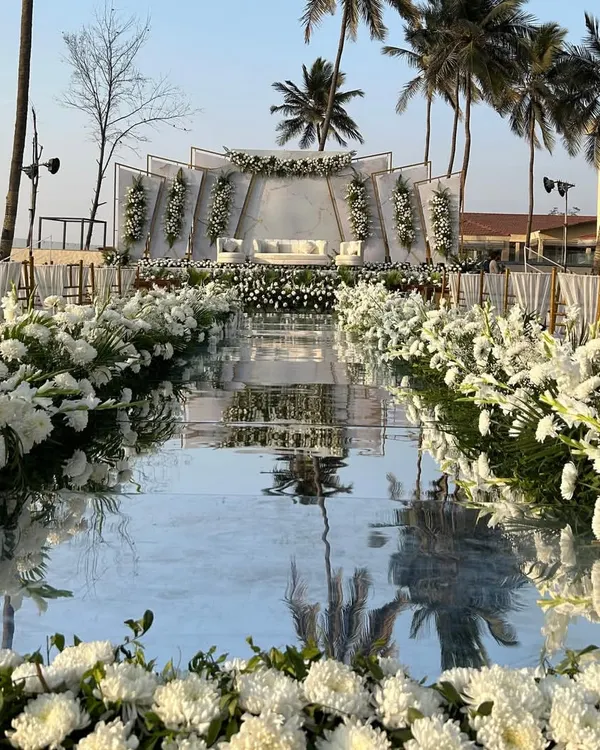 We design unforgettable moments, like this stunning beachside ceremony featuring a reflective mirror aisle that perfectly mirrors the sky. This setup showcases our expertise in creating modern, luxurious Christian weddings and destination events in locations like Goa.