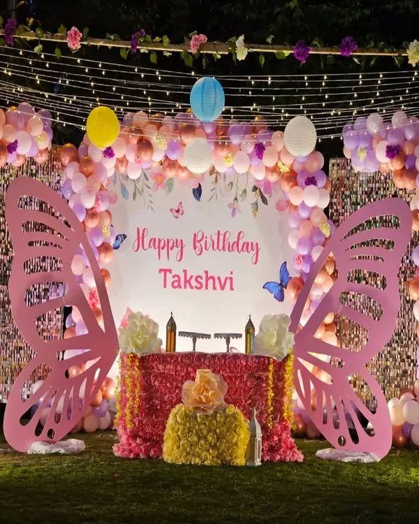Planning your little one's first birthday? We created this magical butterfly wonderland for Takshvi's big day, complete with giant pink butterfly wings for the perfect photo op, a sparkling cake table, and a dreamy balloon arch with fairy lights. We love making first birthdays unforgettable.