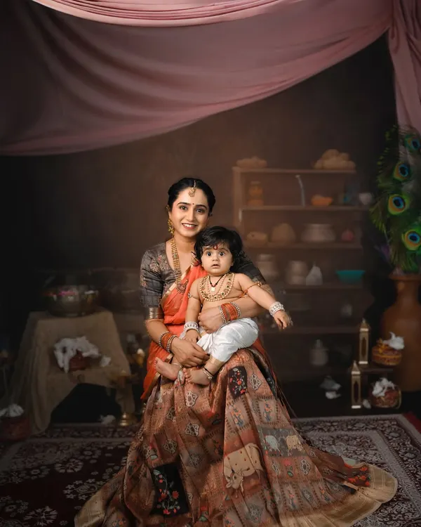 A stunning portrait of Yashoda Maa and her little Kanha. For this Krishna Janmashtami session, I designed a complete set with a traditional backdrop, props, and lighting to create a painterly effect.