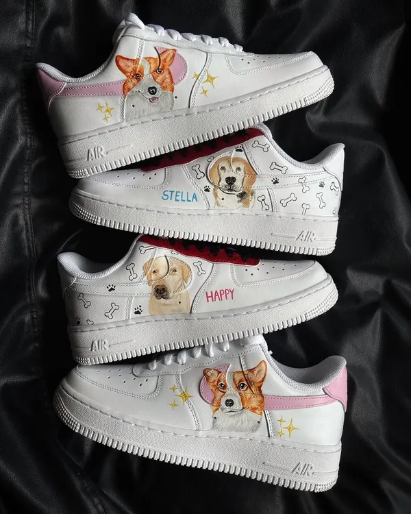 A collection of custom Nike Air Force 1s featuring adorable, hand-painted portraits of different dogs, including a Corgi and a Golden Retriever.