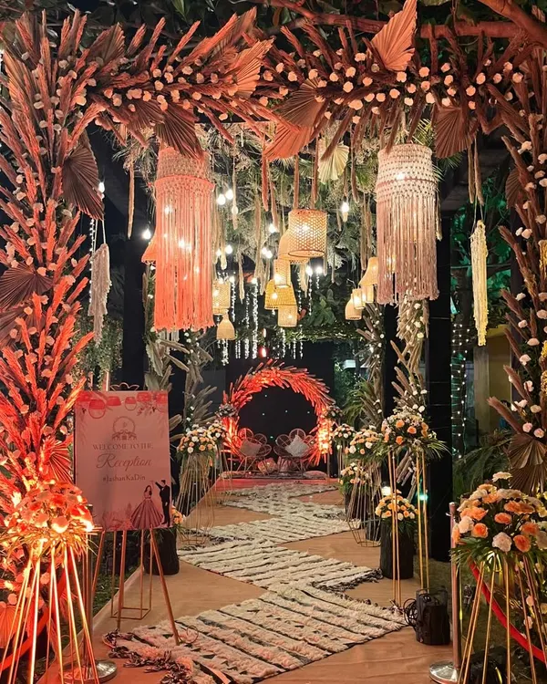 This boho-chic reception entrance sets a magical tone for the evening. We used dried pampas grass, preserved palm leaves, and reusable macrame hangings to create a warm, inviting, and completely sustainable welcome for the guests.
