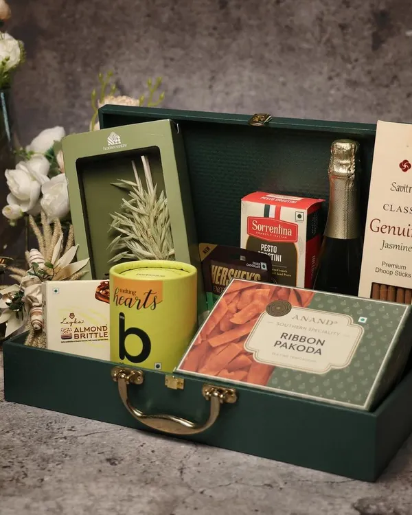 A sophisticated corporate Diwali hamper in a dark green trunk. I teach my students how to balance gourmet food items with non-perishables and elegant decor to create a high-value gift.