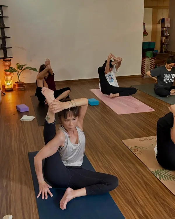 A student in Krounchasana (Heron Pose) during a self-paced class. The community at the shala is inspiring, with everyone working at their own level.