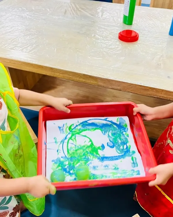 I collaborate, I learn! This is what our 'yes environment' looks like in action. Here, two of our playgroup students work together on a marble art project, learning social skills, teamwork, and creative expression all through the joy of play.