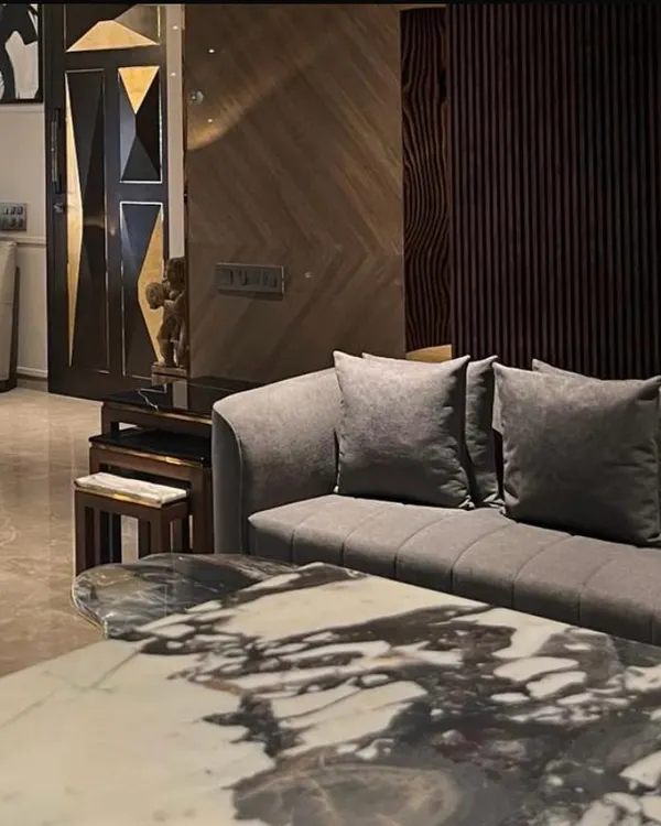 This Juhu apartment is an experience in modern luxury. From the bold geometry of the custom door to the striking marble coffee table, every detail is envisioned to create a dialogue between sophisticated design and a comfortable lifestyle.