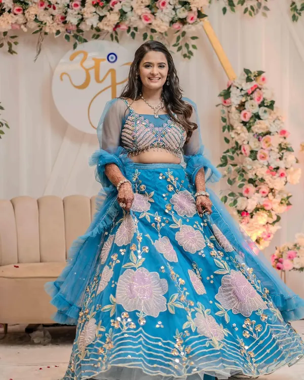 Engagement is all about new beginnings and butterflies. Jinal looked heavenly in this beautiful blue floral lehenga, and we gave her a soft, glowing makeup look to match. 🦋✨