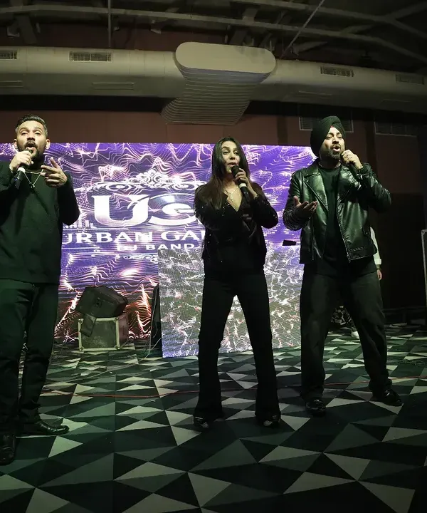 The 'Urban Gabru' band performing live on stage, bringing high energy to a wedding cocktail night. We manage all technical aspects including sound and lighting.