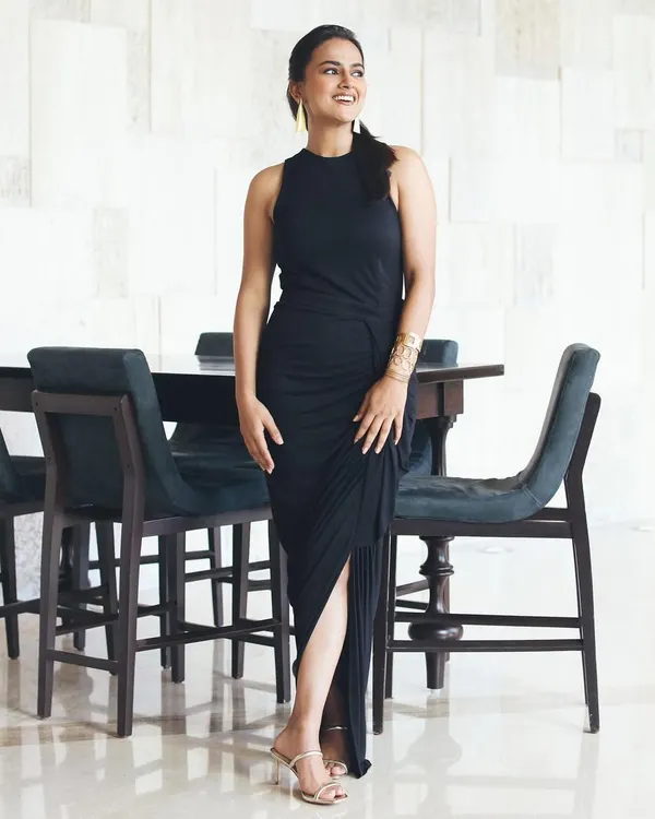 A full-length shot of the elegant black dress I styled for actress Shraddha Srinath's film promotions. The draped fabric and thigh-high slit create a look that is both sophisticated and modern.