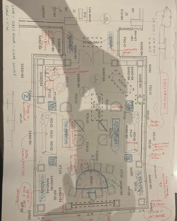 A hand-marked floor plan from our studio. These initial sketches and annotations are where the strategic thinking begins, mapping out furniture layouts, circulation, and spatial experiences.