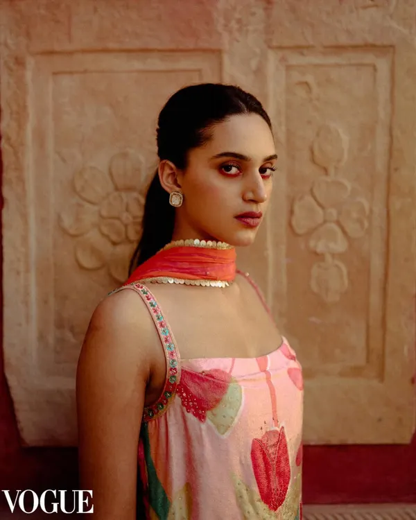 A striking portrait for designer Ruhr, featured on PhotoVogue. The image uses a textured, warm-toned wall as a backdrop to complement the colors of the ethnic wear.