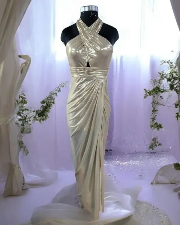 Step into the spotlight with this exquisite golden gown. The shimmering fabric, halter-neck design, and elegant drape create a glamorous silhouette that is perfect for any red-carpet-worthy occasion.
