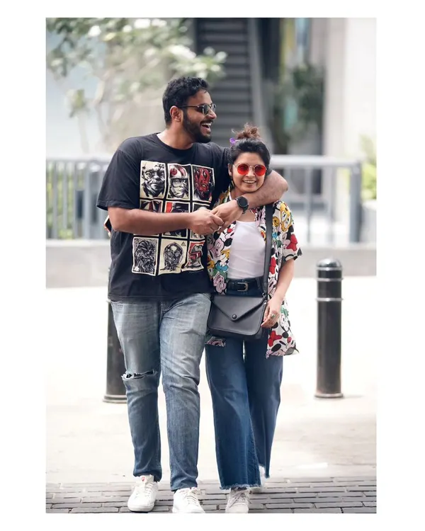 A fun, candid shot of a couple walking down Church Street in Bangalore. Their laughter and casual interaction are what make this urban portrait feel so real and full of life.