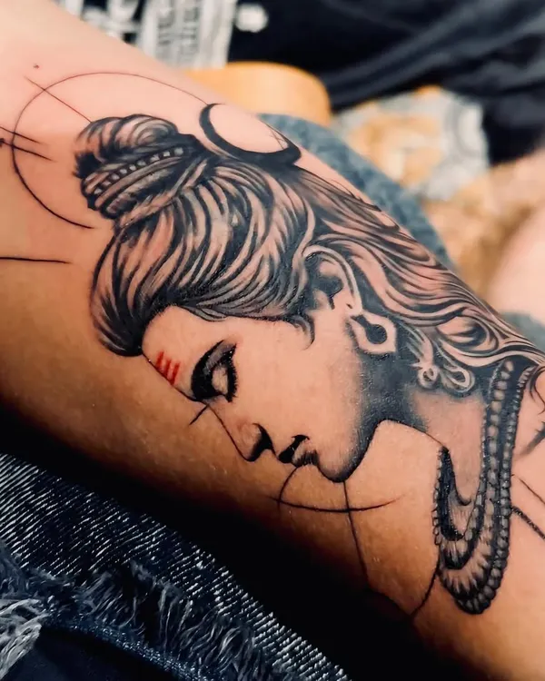 This detailed Lord Shiva tattoo on the forearm captures a serene yet powerful expression. I focused on fine line work for the hair and smooth shading on the face, with geometric accents to create a modern take on a classic spiritual design.