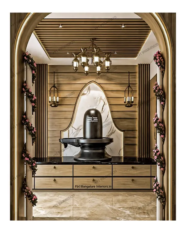Divine serenity and peace. I designed this beautiful pooja space with a Shivling as the centerpiece, set against a marble arch and warm wood paneling. The drawers below provide storage for prayer essentials.
