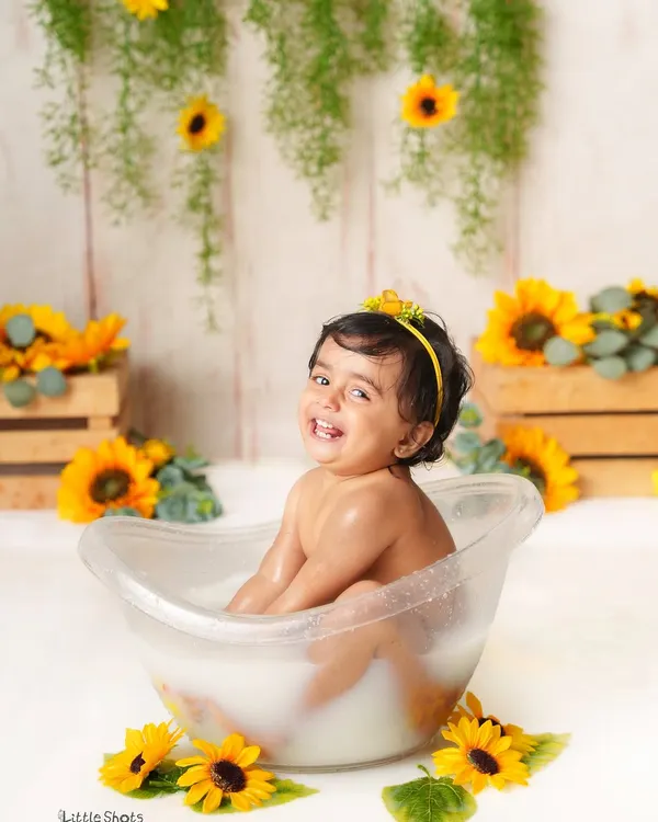 The biggest, happiest smile during a sunflower-themed milk bath session. These splash sessions are all about capturing pure, uninhibited joy.