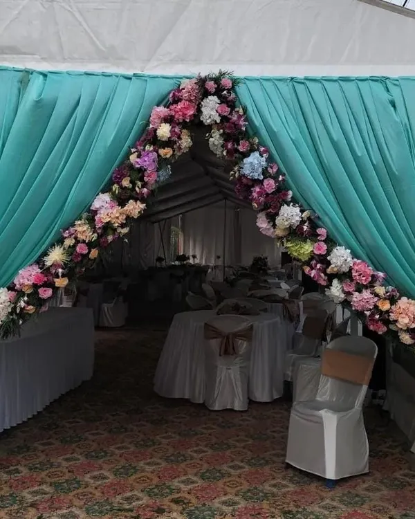 We were thrilled to design the entrance for Columbia Sportswear's office opening. The floral arch and elegant draping in the brand's colors created a welcoming and professional ambiance for the corporate event.