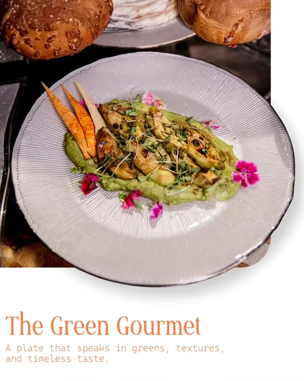 A plate that speaks in greens, textures, and timeless taste. This 'Green Gourmet' dish features grilled artichokes on a bed of avocado puree, garnished with edible flowers and microgreens for a fresh, elegant start.