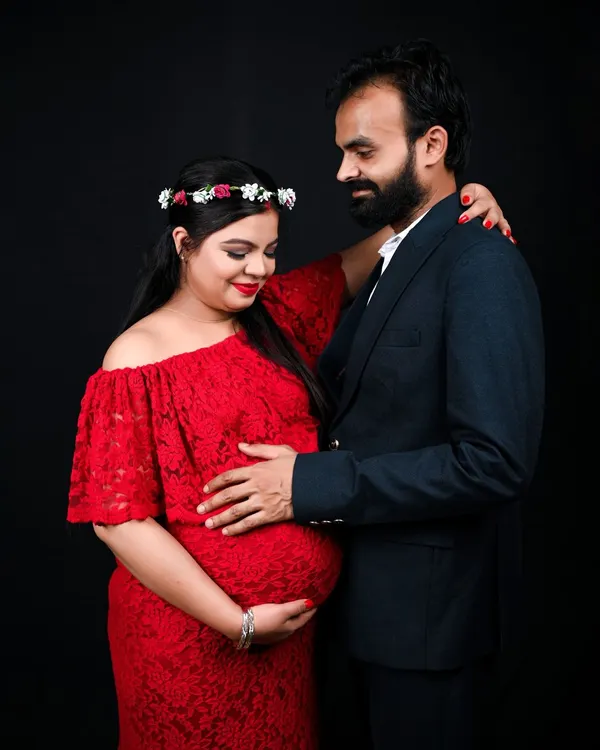 A classic and intimate couple's maternity portrait. The simple black background in my studio really makes the connection between the parents to be stand out.