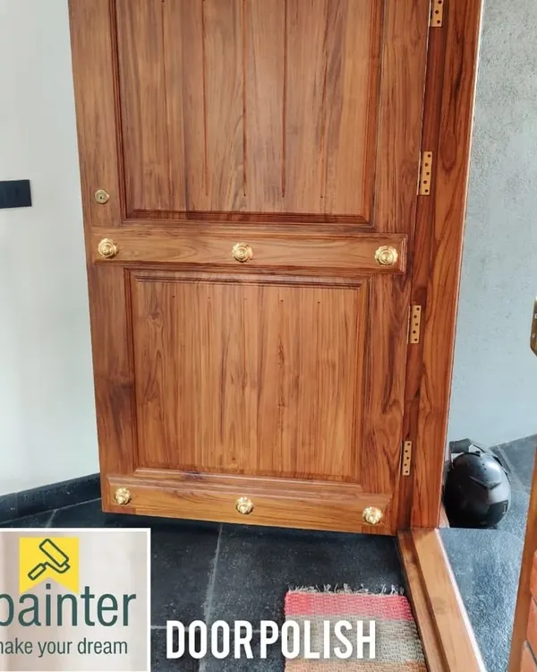 A main door with a flawless natural wood polish. This finish protects the teak wood while highlighting its beautiful grain and color.
