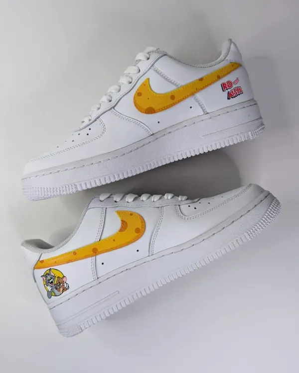 The inner side of the Tom and Jerry AF1s, featuring a cheese-themed swoosh and the "Rat of Air" text for a playful touch.