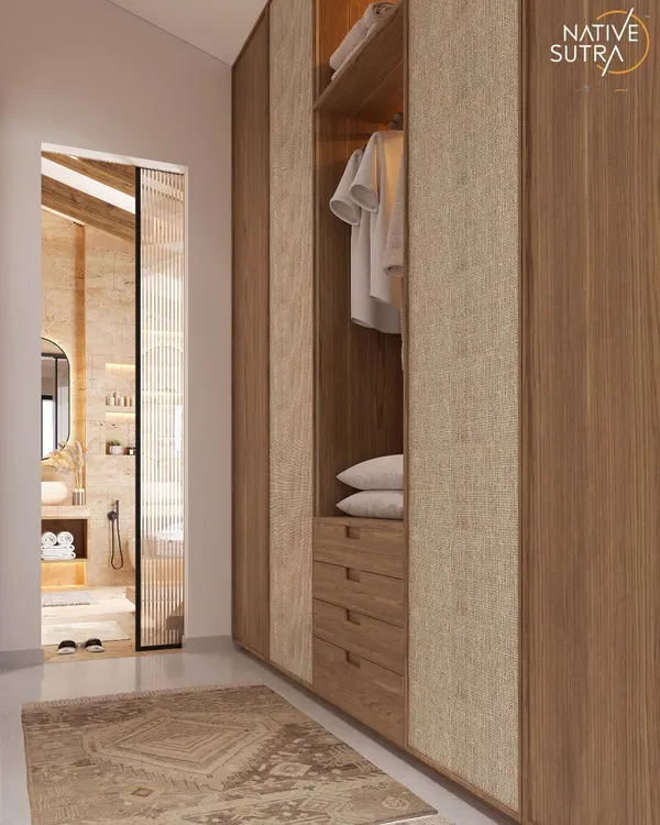 Less clutter, more calm. This walk-in closet features textured fabric and warm wood grain shutters, with a layout that breathes. It's a perfect example of how we design functional spaces that feel like quiet luxuries.