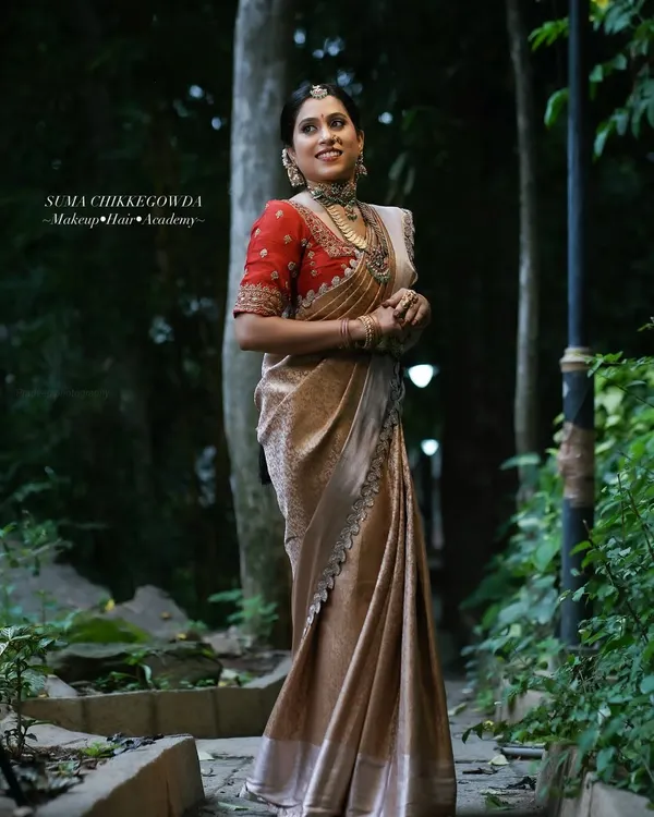 A full-length portrait of a timeless Muhurtham look, showcasing the elegant fall of the Kanjivaram saree and the overall poise of the bride.