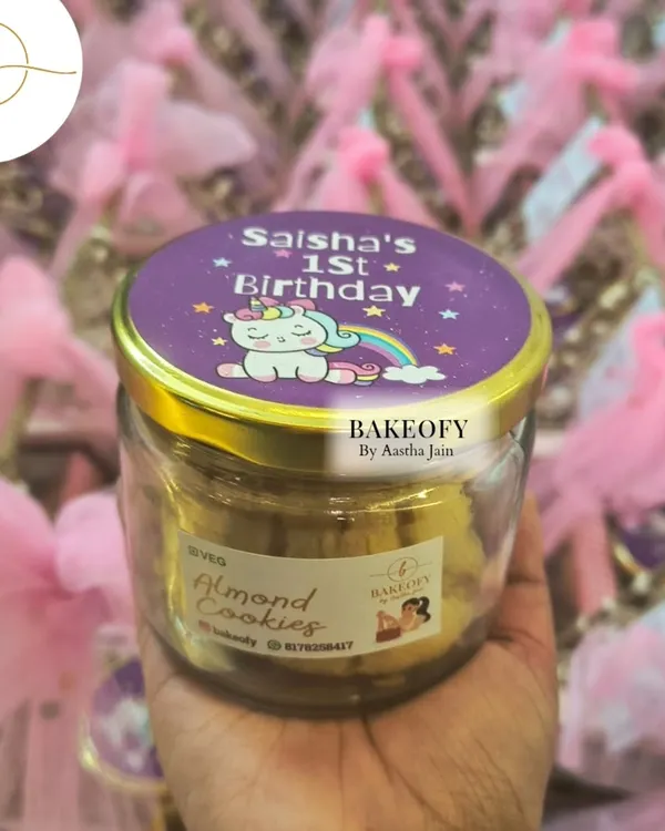 I create beautiful, customized gift hampers for all your special occasions. This one, for a first birthday, features a jar of my handcrafted almond cookies with a personalized unicorn-themed label.